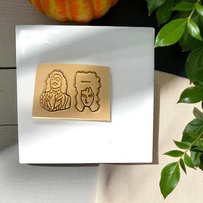 Clay slab with Beetlejuice and Lydia impressions on white tile