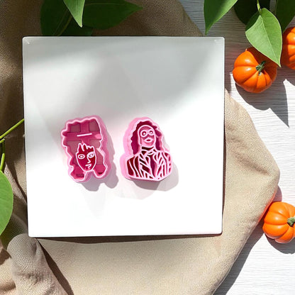 Pink Beetlejuice and Lydia clay cutters on white tile with pumpkin