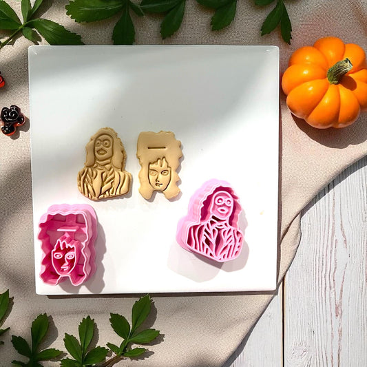 Beetlejuice and Lydia clay impressions with cutters on white tile