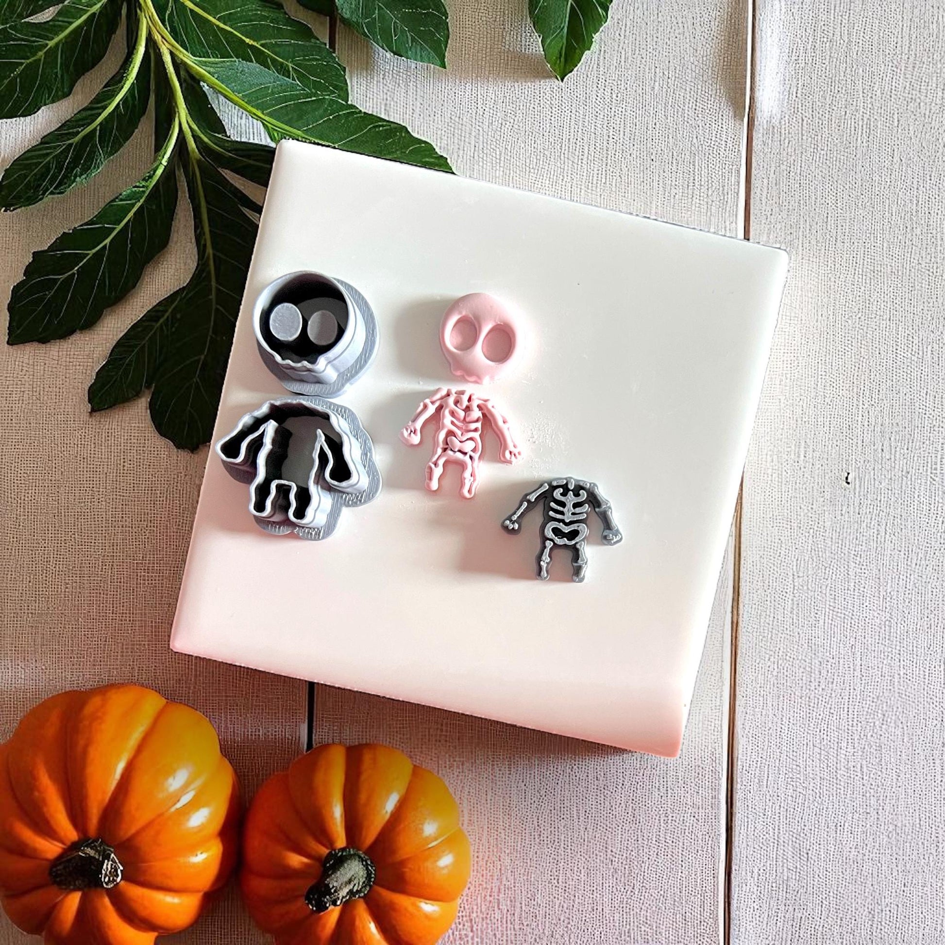 Skeleton cutters with pink clay impression on white tile