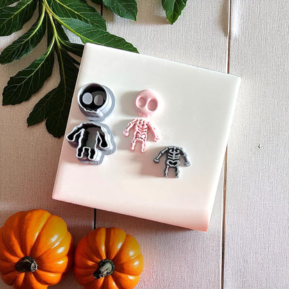 Skeleton cutters with pink clay impression on white tile
