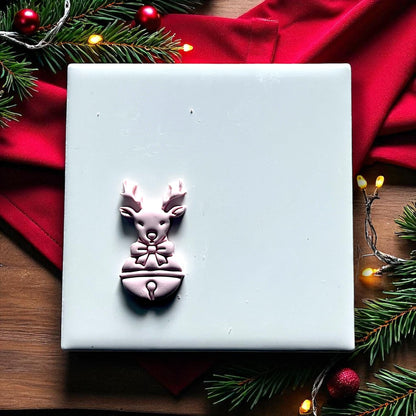 Reindeer polymer clay cutter on white tile with red fabric and lights