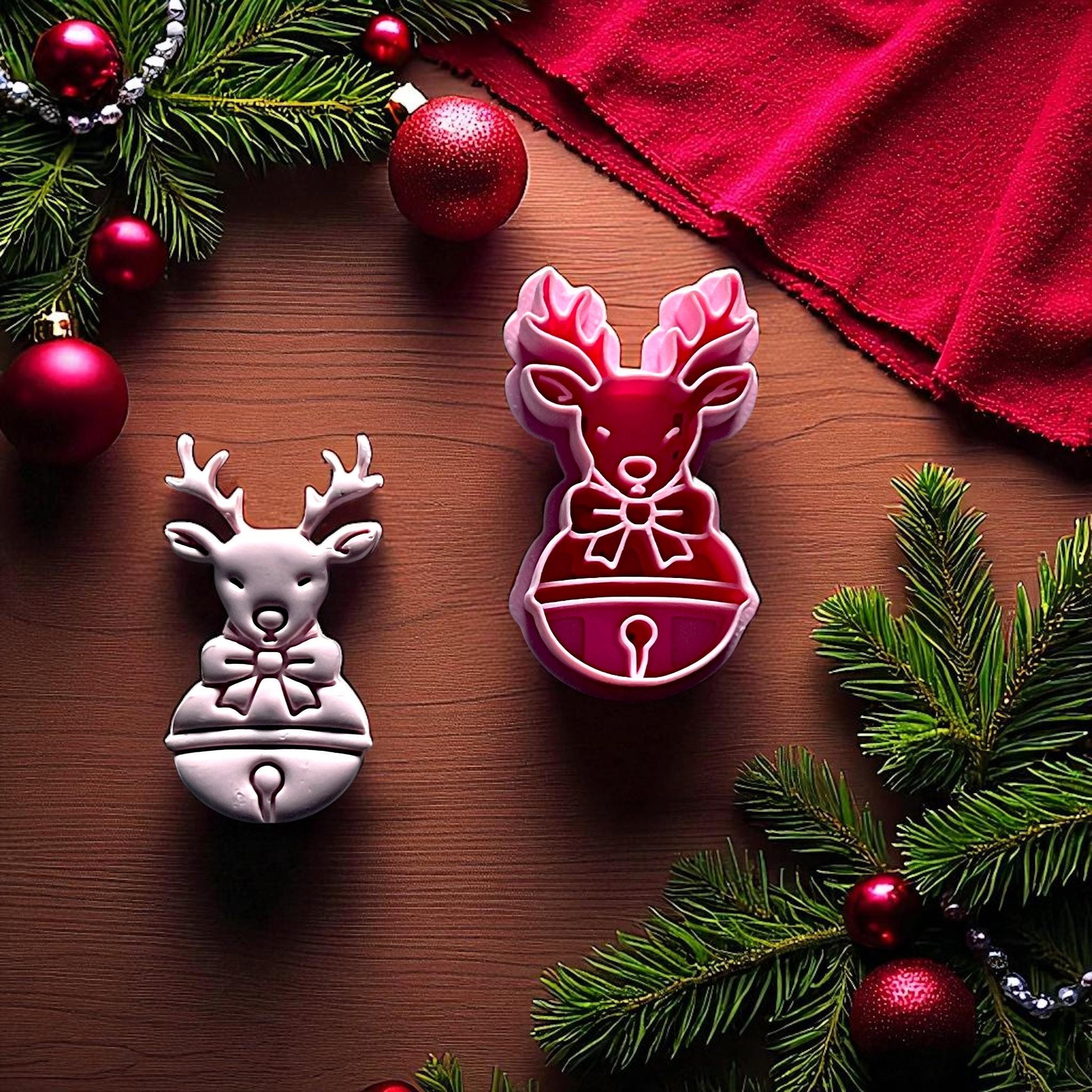 Reindeer clay imprint and cutter side by side with greenery and ornaments