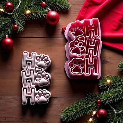 Ho Ho Ho paw print clay imprint beside red cutter on wood background