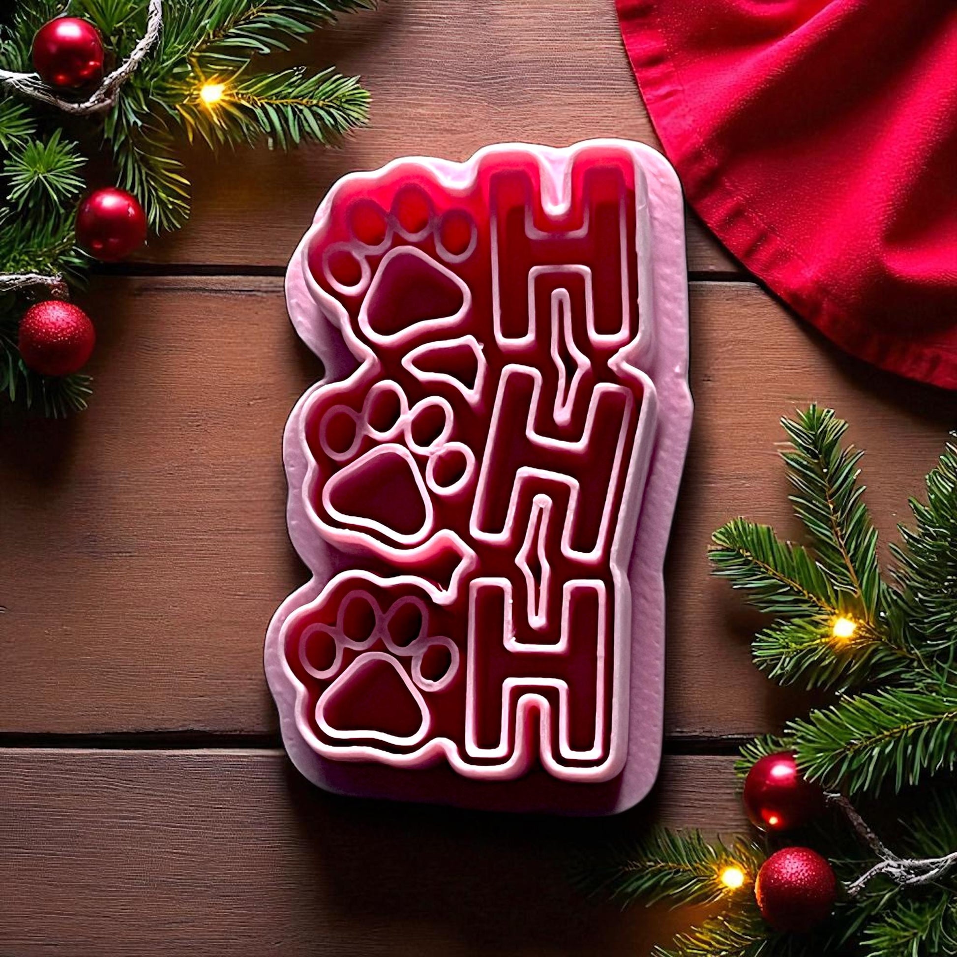 Close up of Ho Ho Ho paw print polymer clay cutter with Christmas decor