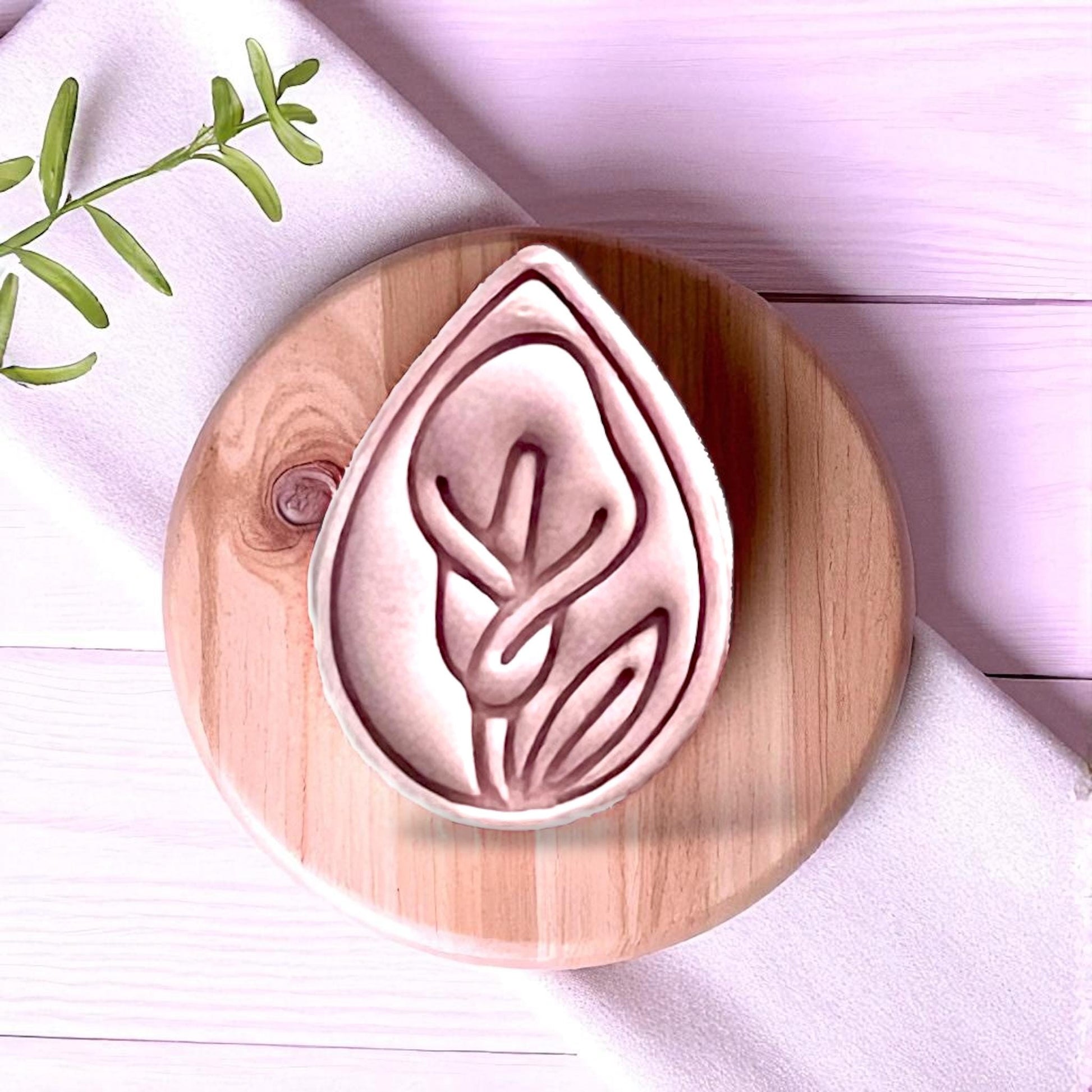 Close-up of calla lily clay imprint on wooden board