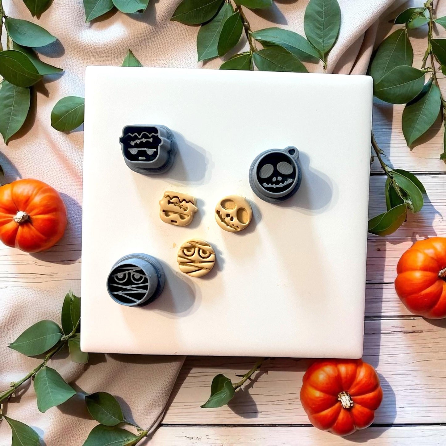 Halloween clay cutters with matching clay imprints on white tile