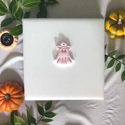 Cowboy ghost clay shape on tile with greenery and pumpkins