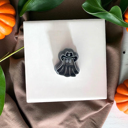 Cowboy ghost clay cutter on white tile with pumpkins