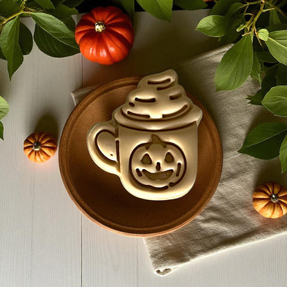 Pumpkin mug latte clay design on wooden plate with pumpkins