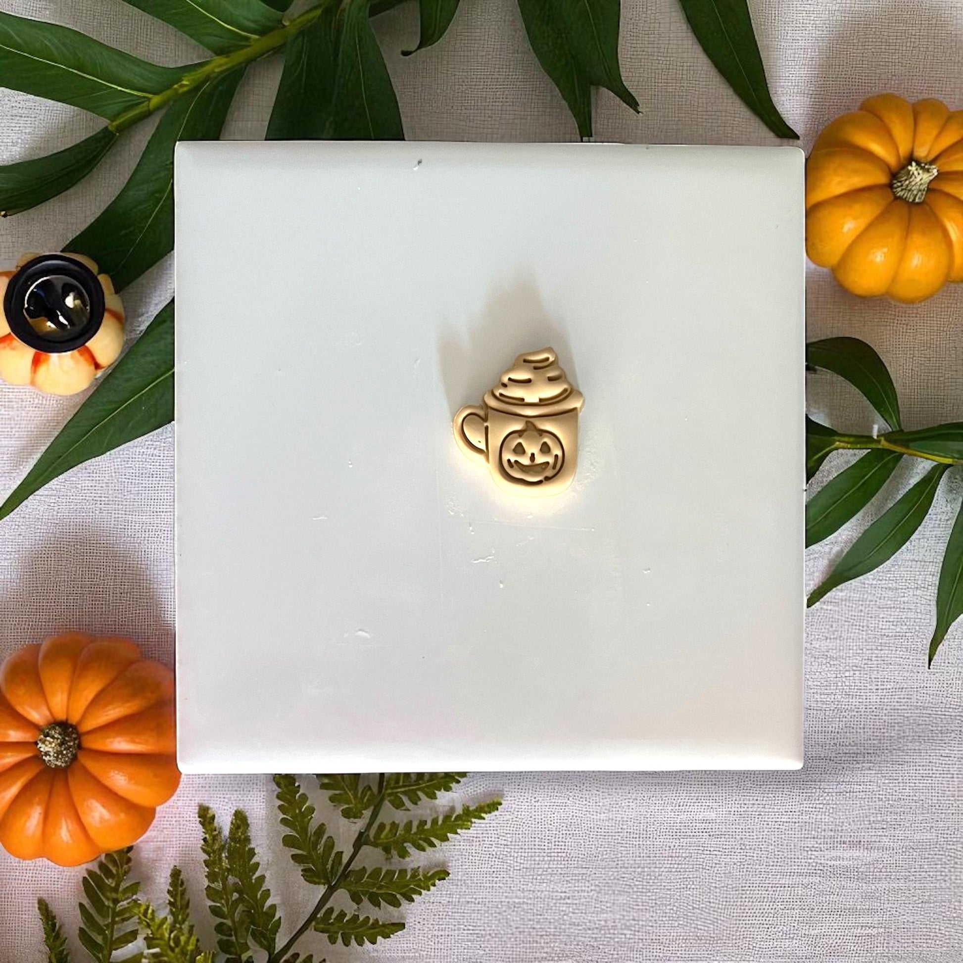 Pumpkin mug clay imprint on yellow clay with autumn leaves