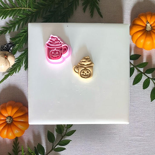 Halloween pumpkin mug clay piece on white tile with pumpkins