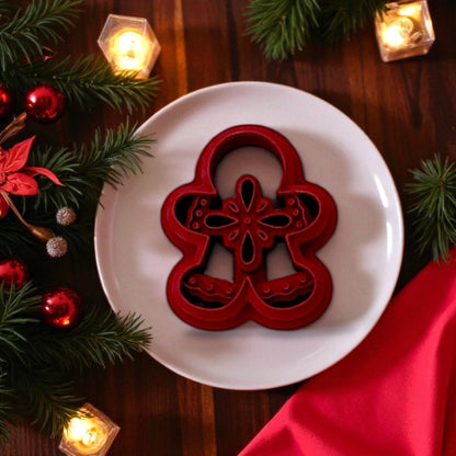 Red boho gingerbread man polymer clay cutter on plate with Christmas lights