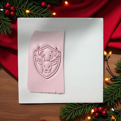 Reindeer clay imprint on pink clay slab with Christmas lights