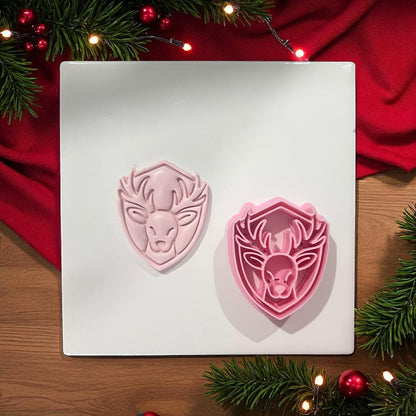 Reindeer cutter and clay imprint side by side on white board