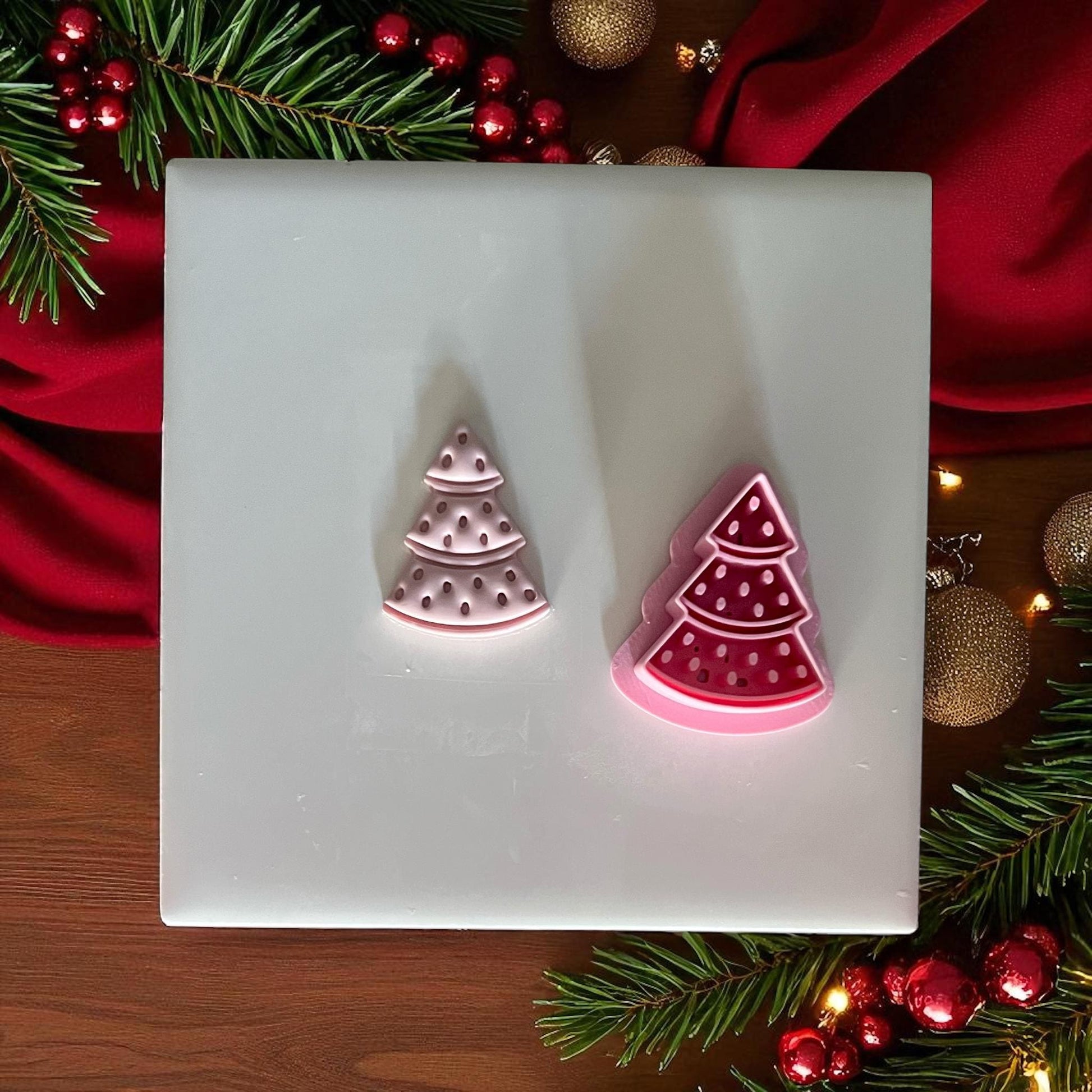 Watermelon tree clay imprint and cutter side by side on white tile