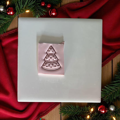 Watermelon Christmas tree clay imprint on pink clay slab with holiday lights