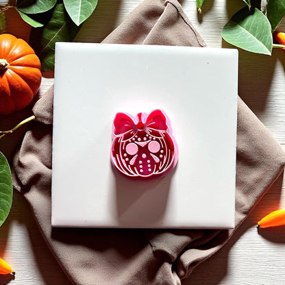Jason mask pumpkin with bow pink clay cutter on white tile
