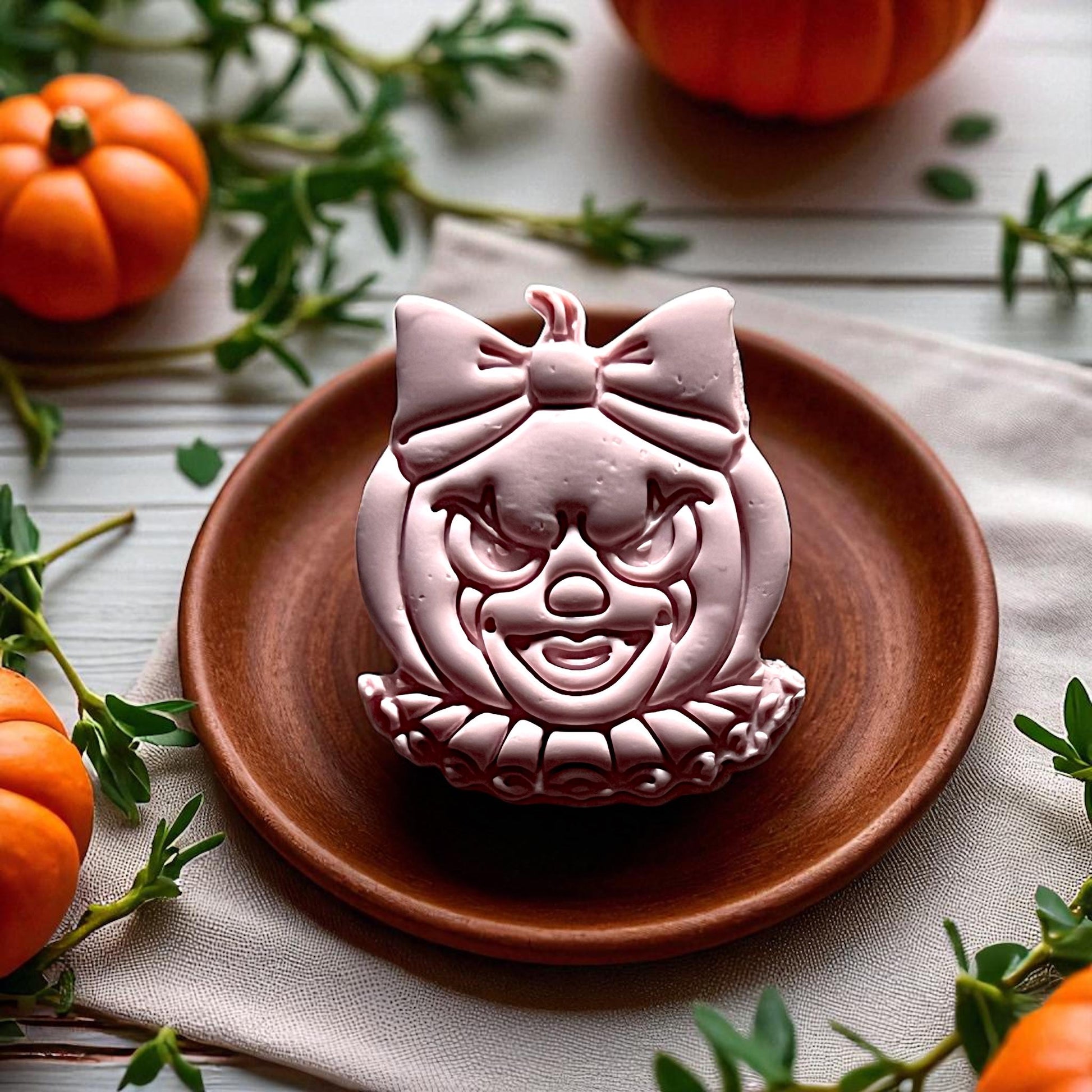 Large clown pumpkin clay imprint with bow on wooden plate