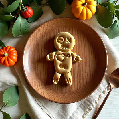 Large voodoo doll clay piece on wooden plate with pumpkins and greenery