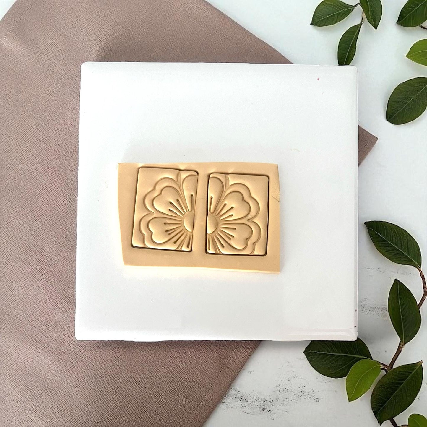 Two rectangular flower clay imprints pressed into sheet