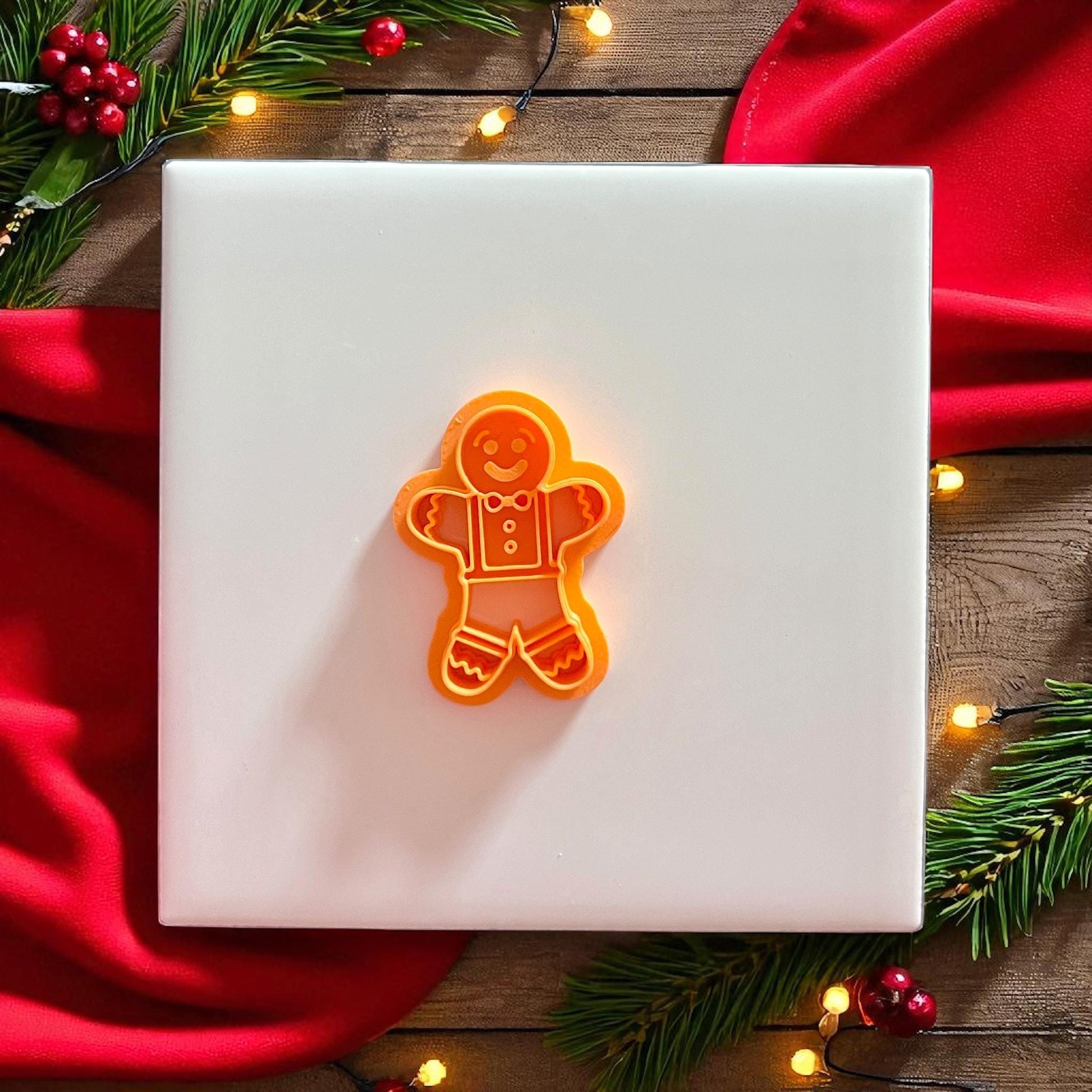 Orange gingerbread man cutter with clay imprint