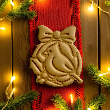 Closeup of festive cardinal clay impression on red ribbon and lights