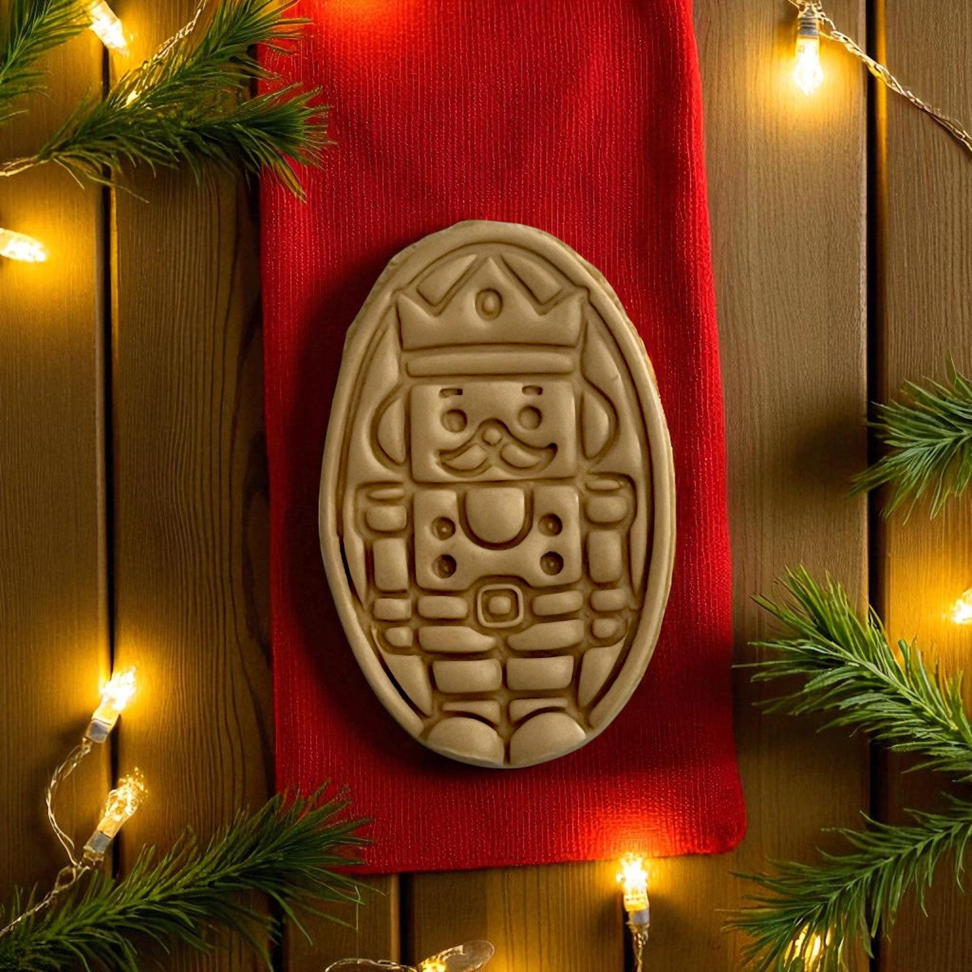 Close-up of nutcracker clay design with red background and twinkle lights