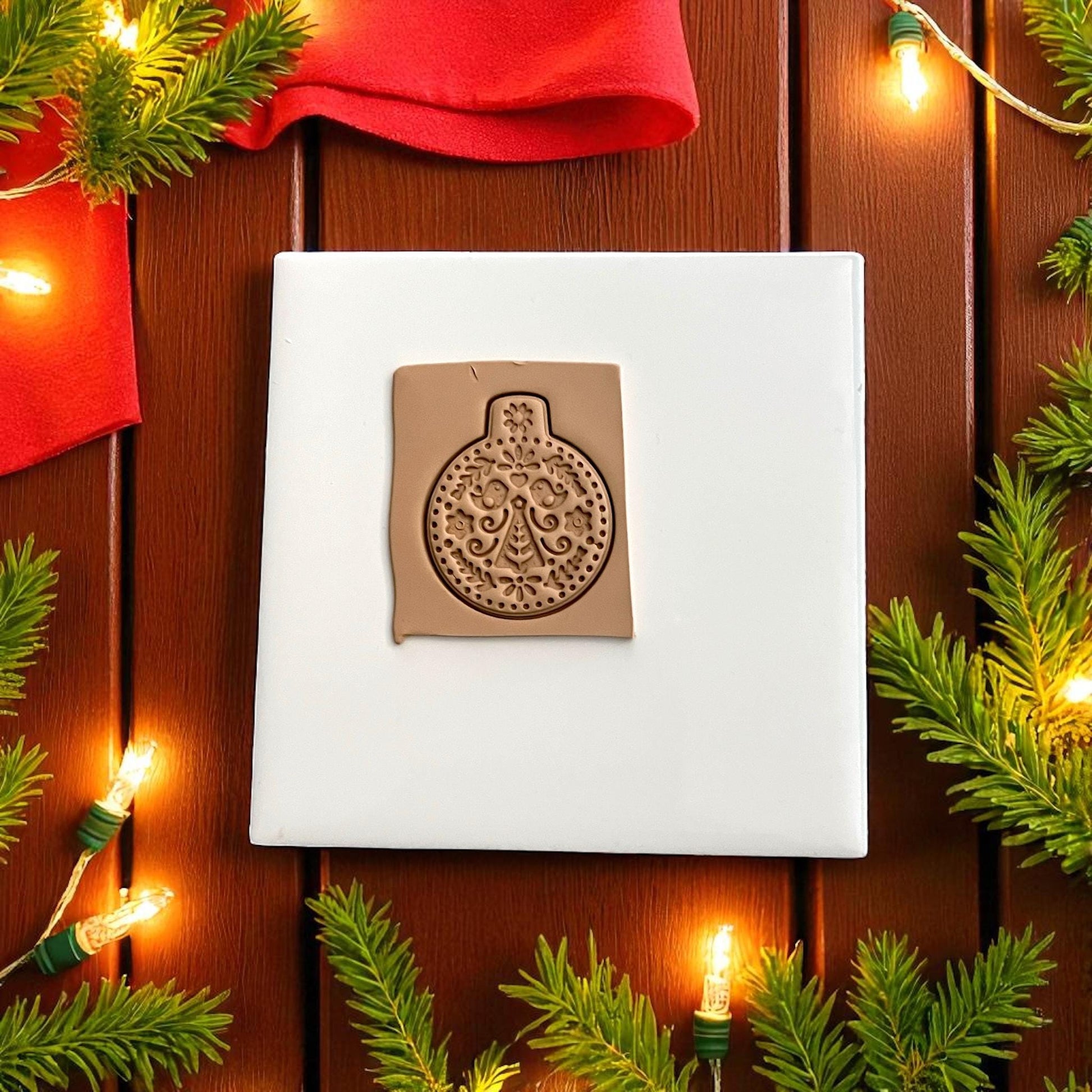 Scandinavian ornament polymer clay imprint with folk tree and birds on tan clay