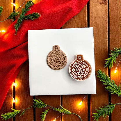 Ornament polymer clay cutter and imprint shown together with festive lights