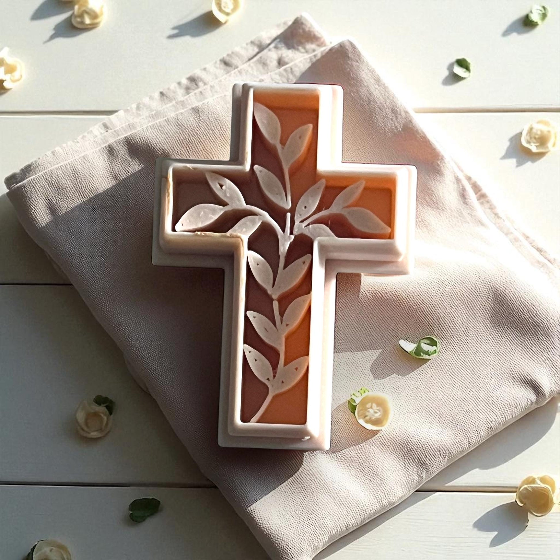 Ivy cross polymer clay cutter on beige fabric with flower petals