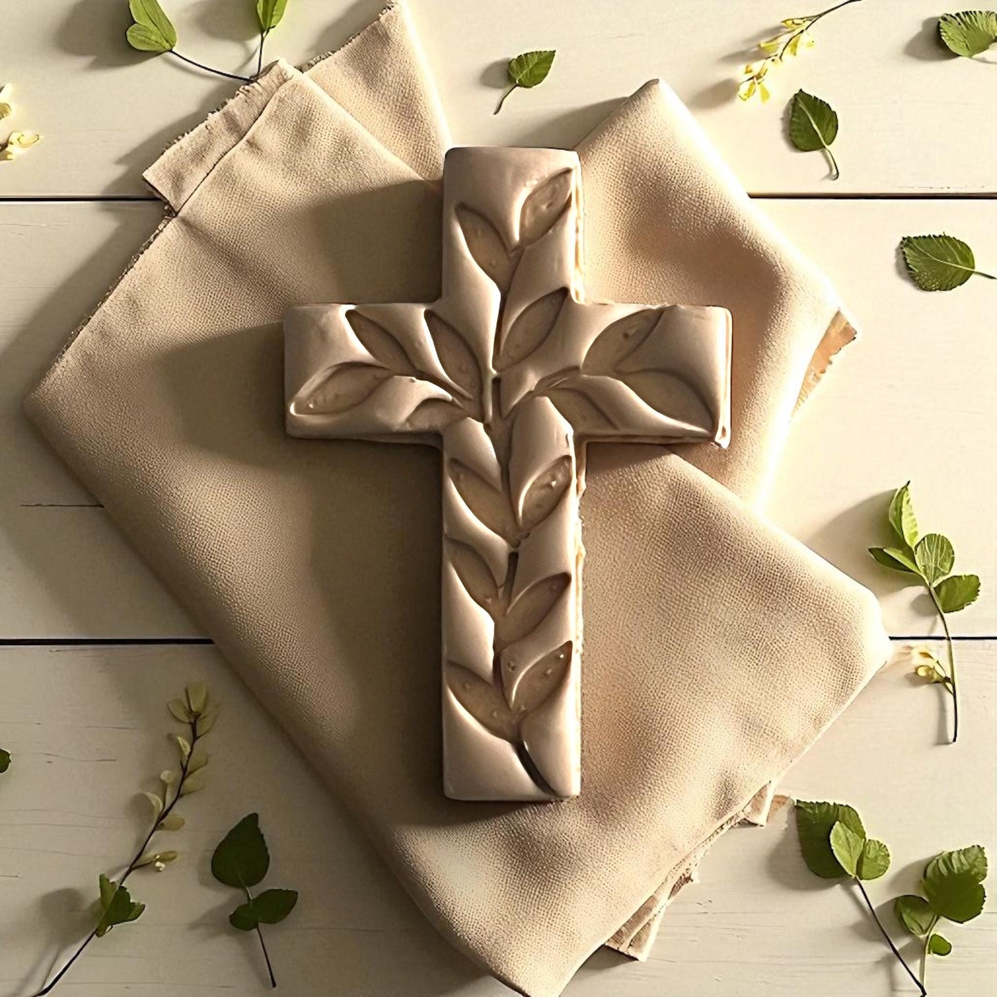 Large ivy cross clay impression on fabric with green leaves