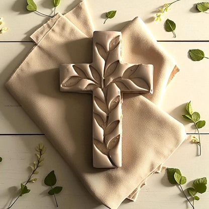 Large ivy cross clay impression on fabric with green leaves