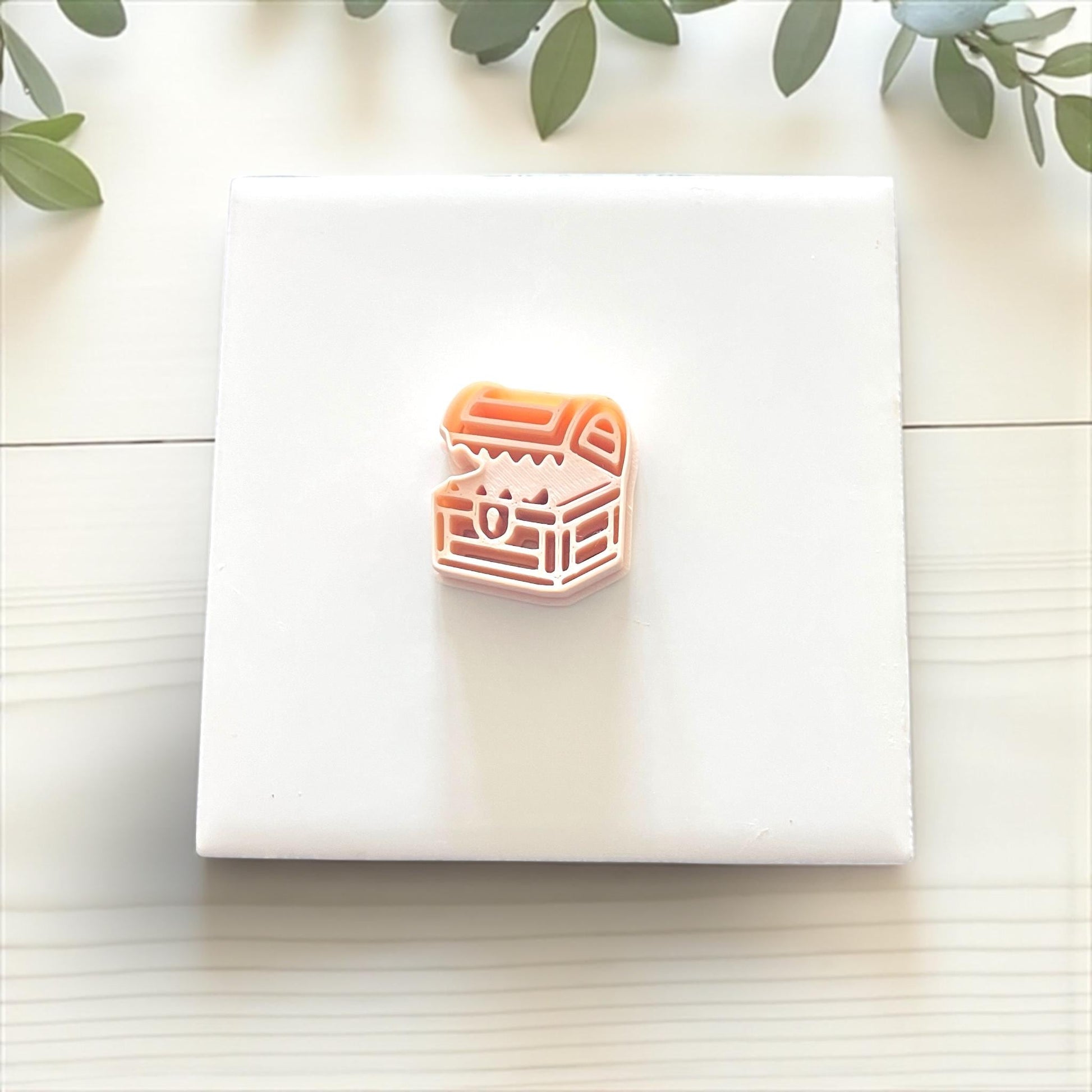 Single mimic chest clay impression on white tile with beige napkin