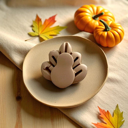 Thanksgiving turkey clay cutters displayed on white tile with pumpkins and yellow leaves