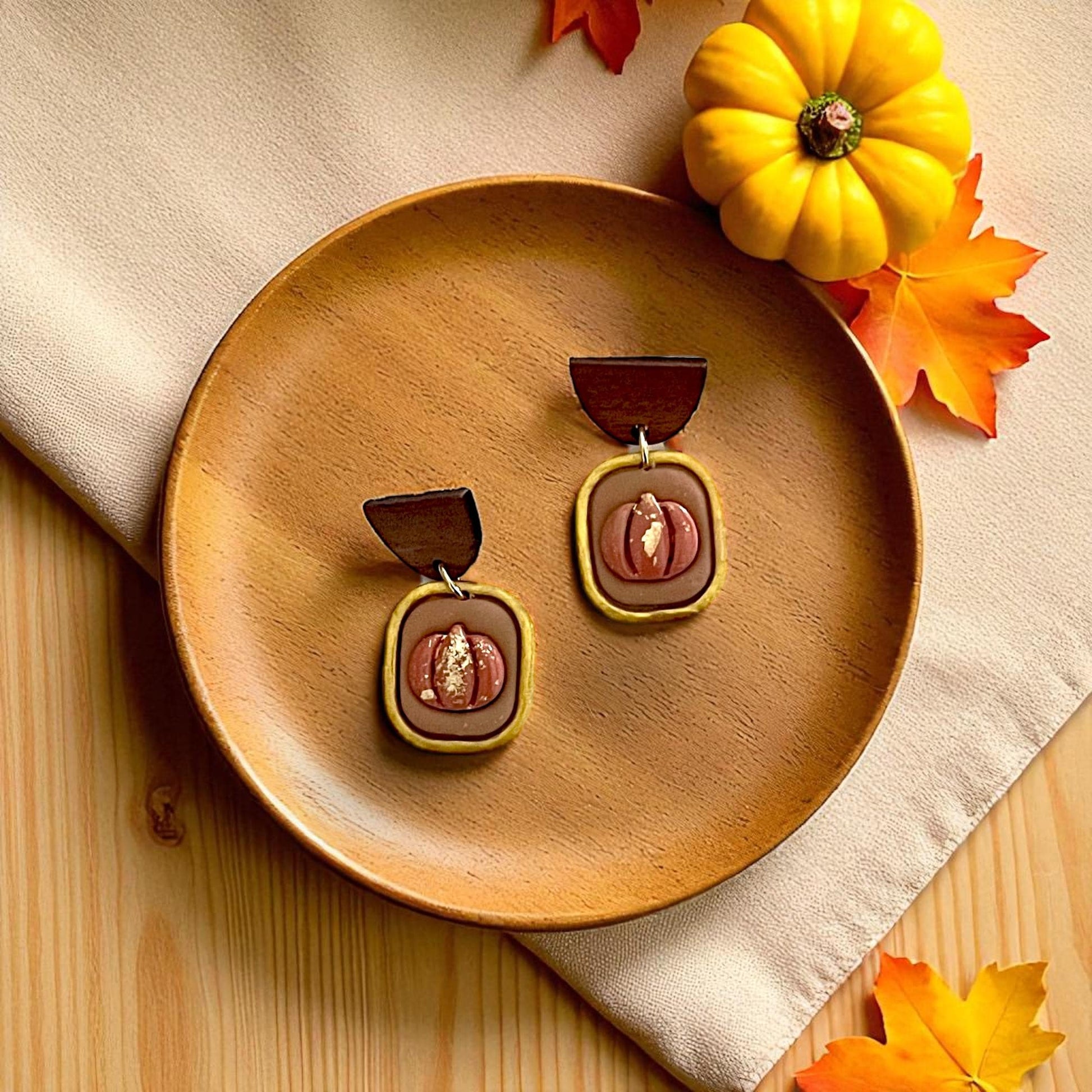 Pumpkin frame polymer clay cutters displayed on white tile with pumpkins and leaves