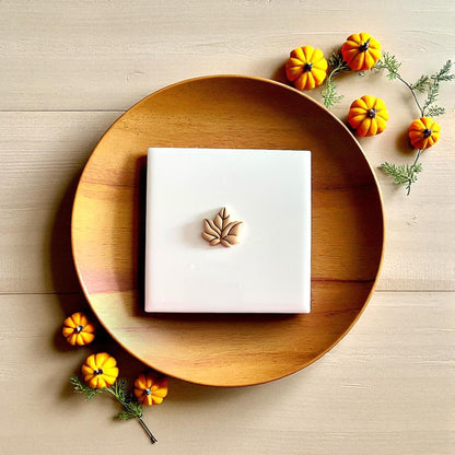 Fall leaf clay design on rustic wooden tray with pumpkins and autumn leaves