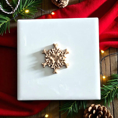 closeup snowflake polymer clay impression on red napkin with Christmas lights