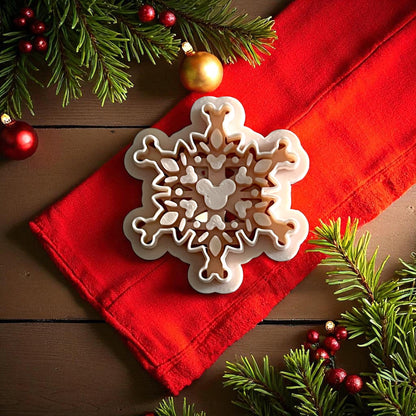 mouse snowflake polymer clay cutter on red fabric with pine branches