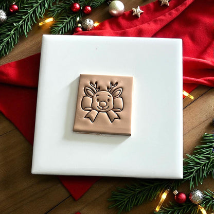 reindeer bow cutter and clay impression side by side on festive white tile