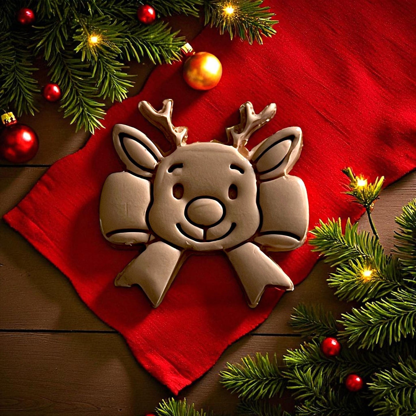 reindeer bow clay imprint centered on white tile with red background