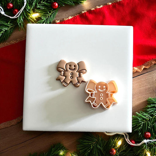 Gingerbread clay cutter with holiday décor on red napkin and wood background