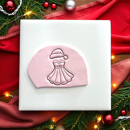 Polymer clay cutter of Mrs Santa dress with hat on white tile