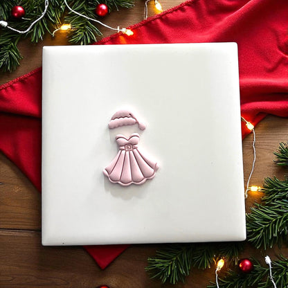 Cutter and clay imprint of Mrs Santa dress and hat side by side