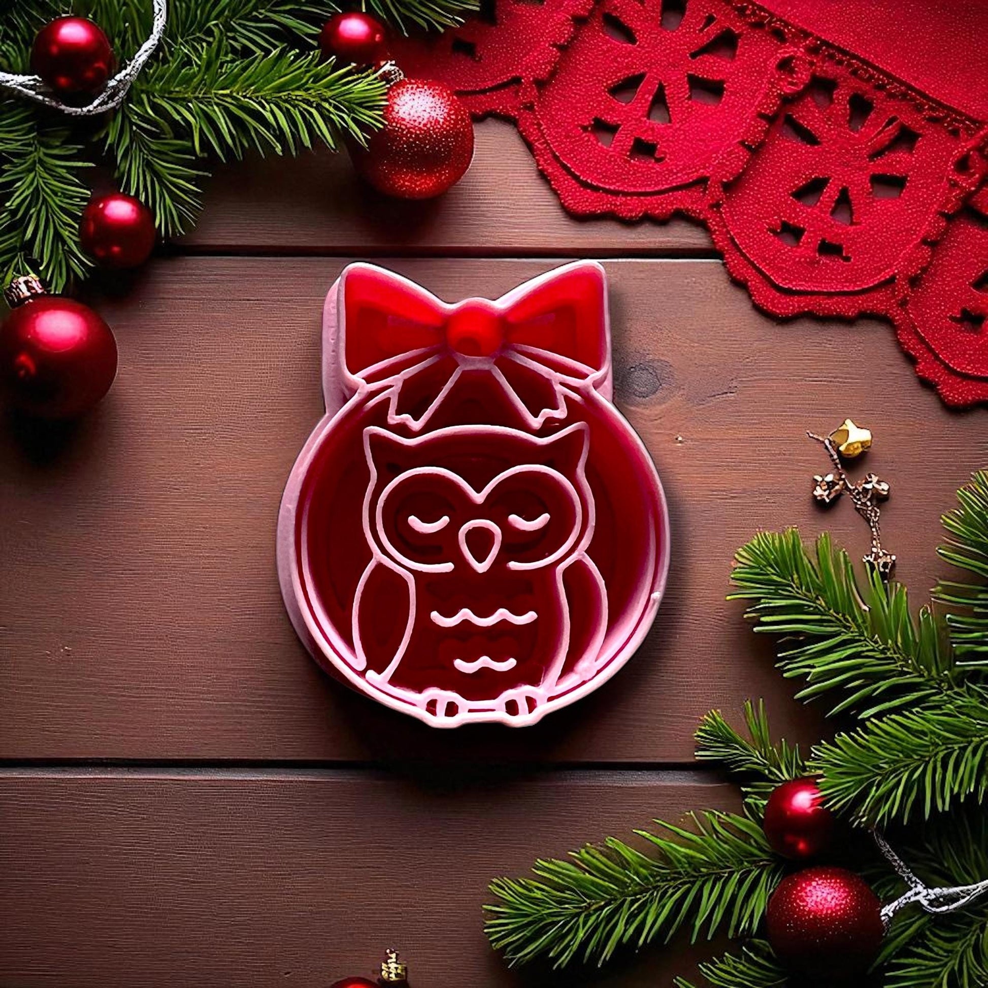 Close-up owl ornament clay cutter with bow and Christmas decor