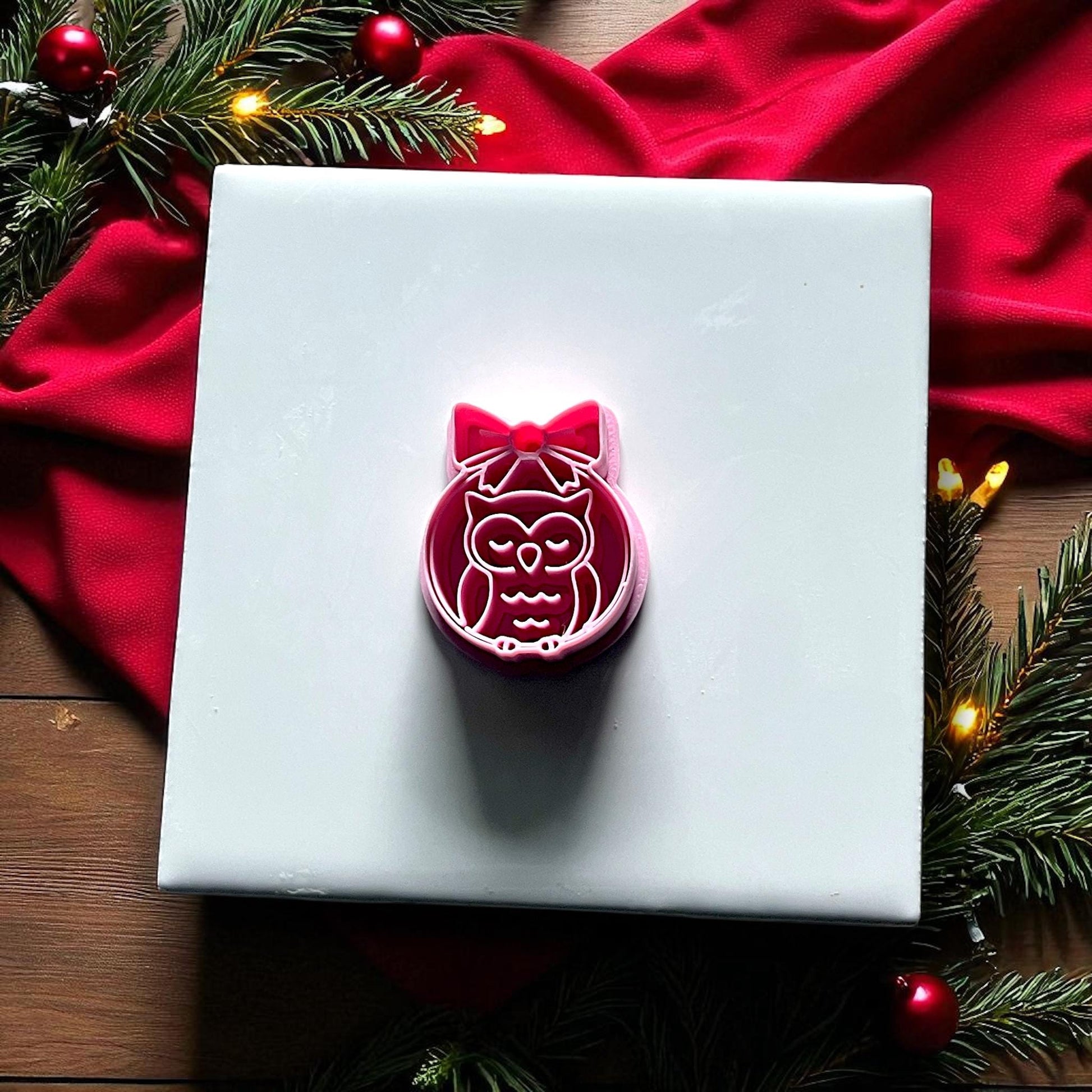 Pink owl ornament polymer clay cutter on holiday background