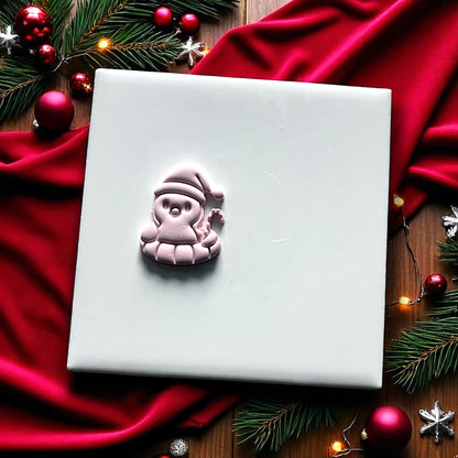 Penguin floatie Christmas clay imprint on white tile with red fabric