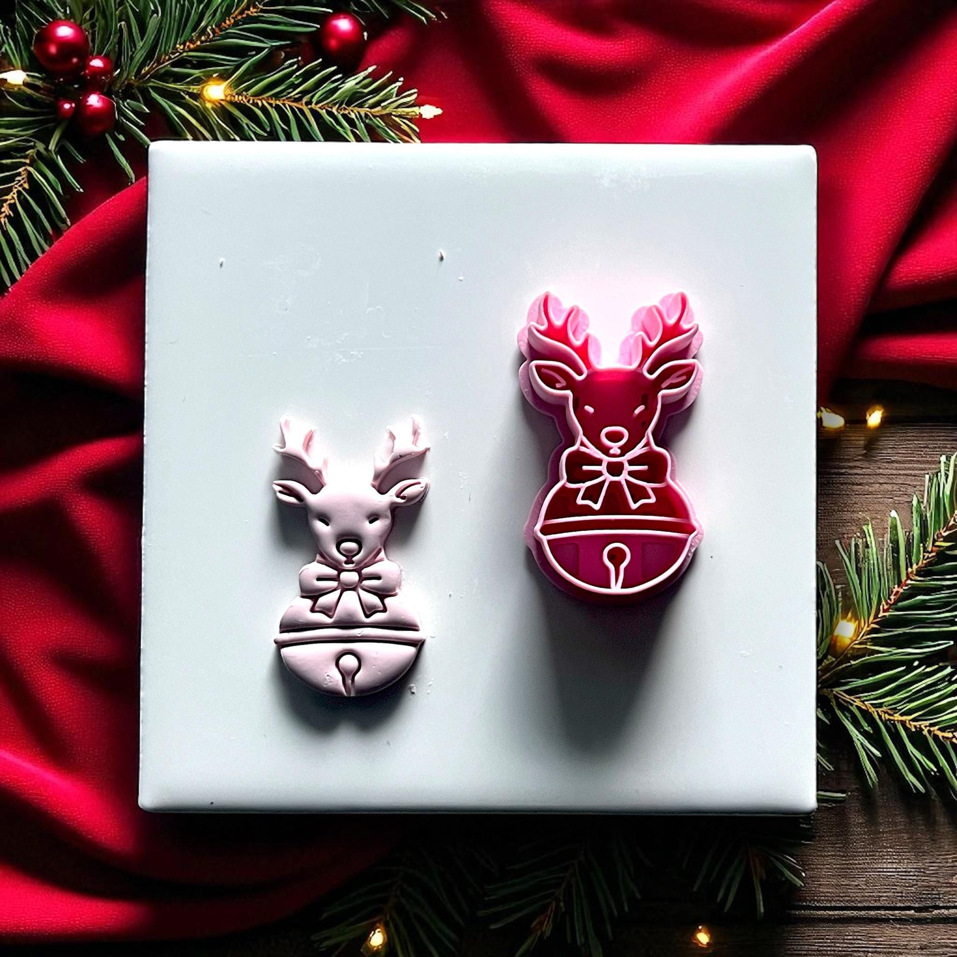 Large reindeer clay imprint with bow and bell on wooden surface