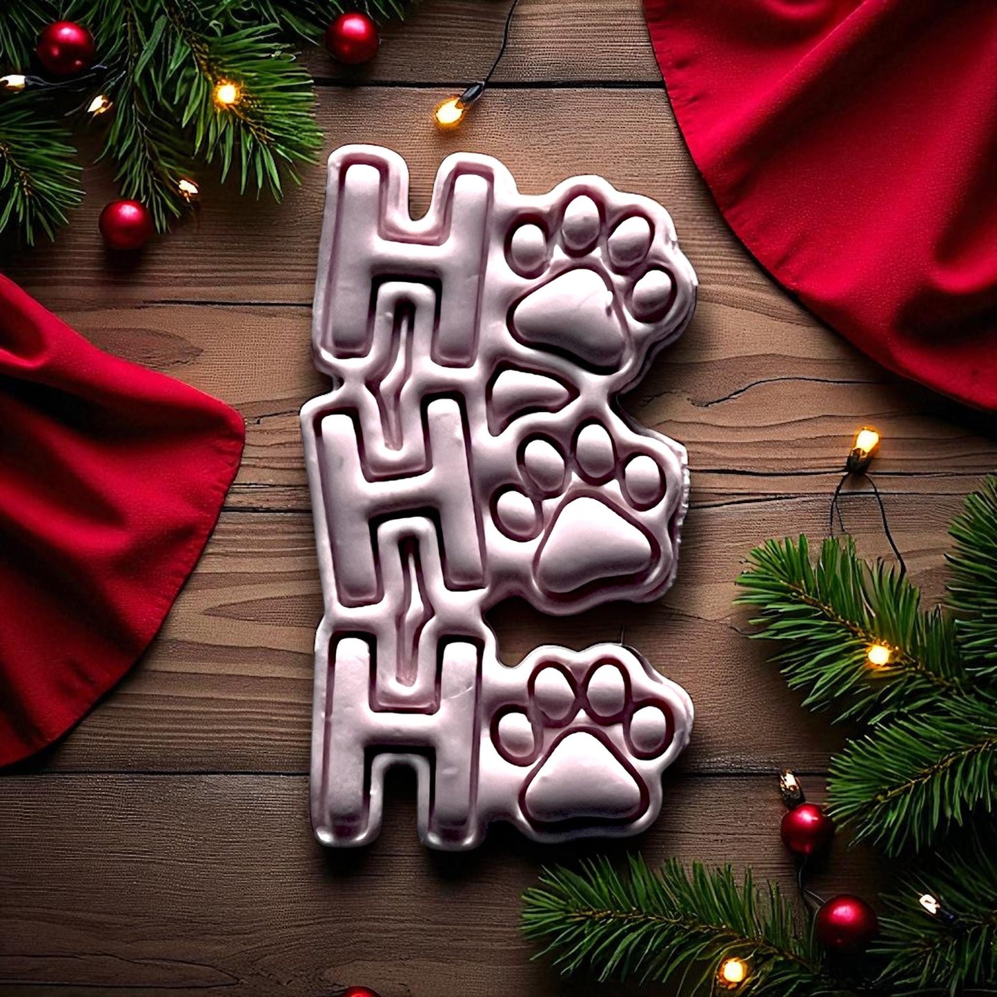 Large Ho Ho Ho paw print clay imprint with red Christmas fabric and greenery
