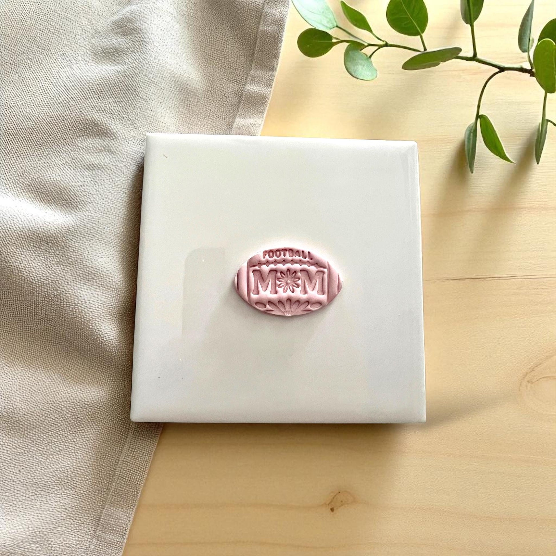 Football mom floral clay imprint on white tile